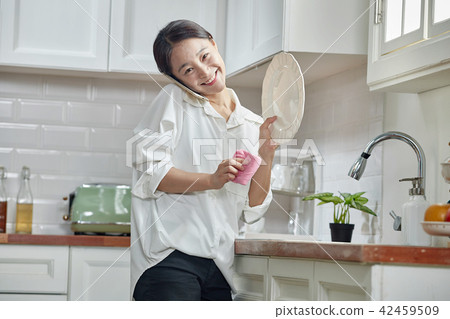 Washing dishes in a single-life kitchen 42459509