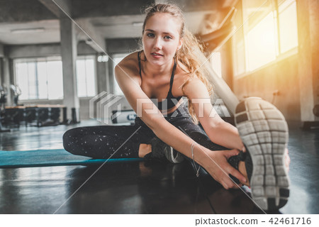 woman stretching before exercise in gym woman stretching before exercise in gym 42461716