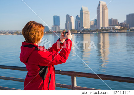 Young woman takes photos using smart mobile phone 42463105