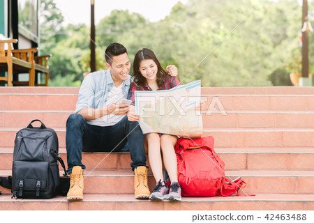 couple traveler holding map and smart phone mobile couple traveler holding map and smart phone mobile 42463488