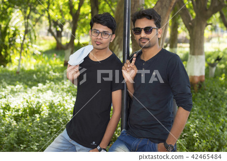 Two handsome men in casual clothes in park Two handsome men in casual clothes in park 42465484