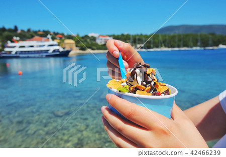Girl eating ice cream 42466239