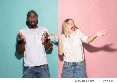 Beautiful woman and afro woman looking suprised isolated on pink Beautiful woman and afro woman looking suprised isolated on pink 42466340