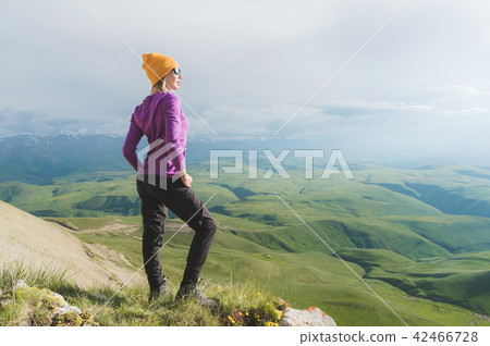 A hipster girl in a straw hat and glasses on the nature landscape A hipster girl in a straw hat and glasses on the nature landscape 42466728