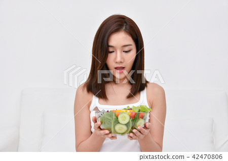 The concept of nutritional food. Beautiful girl takes care of he 42470806