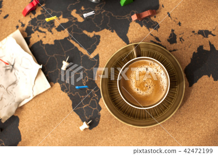 A cup of fragrant coffee on the map, a vintage photo. Travel and holidays. Copy space 42472199