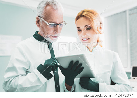 Two successful scientists checking the results of research Two successful scientists checking the results of research 42472374