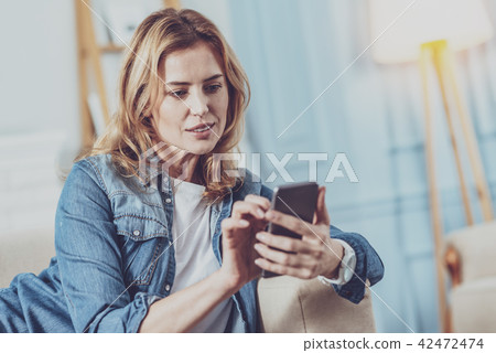Concentrated female person typing message Concentrated female person typing message 42472474