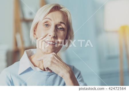 Cheerful elderly woman posing on camera Cheerful elderly woman posing on camera 42472564