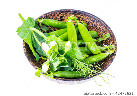 Wooden bowl with pods of green peas Wooden bowl with pods of green peas 42472621