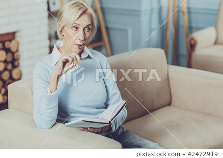 Thoughtful retirement working at her project 42472919