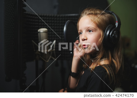 little girl singing in recording studio 42474170