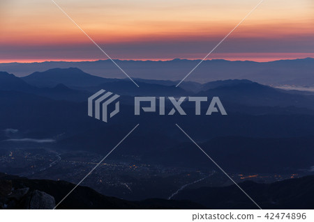 Morning glow and mountain ranges stained red 42474896