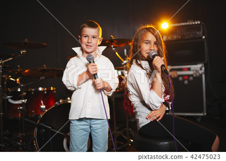 boy and girl singing in recording studio boy and girl singing in recording studio 42475023