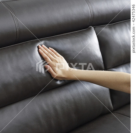 A hand touching a soft sofa A hand touching a soft sofa 42475346