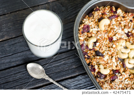 Glass of yogurt and granola with cashews Glass of yogurt and granola with cashews 42475471