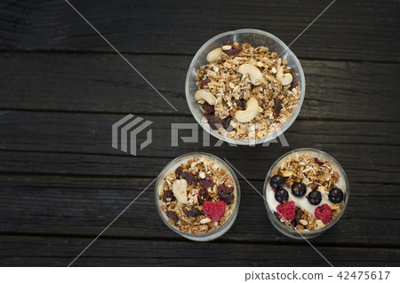 Granola with cashew in a cup with yoghurt Granola with cashew in a cup with yoghurt 42475617