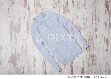 Fashionable concept. Blue striped shirt. Top view Fashionable concept. Blue striped shirt. Top view 42476270