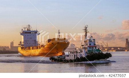 pilot a ship is navigating a cargo ship pilot a ship is navigating a cargo ship 42477037