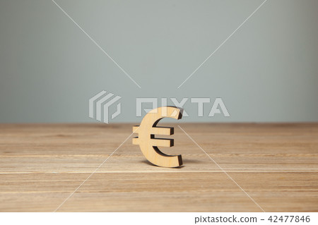Euro symbol of wood on wooden table 42477846