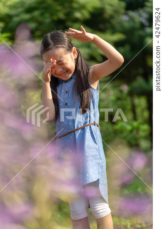 A child who is happy by holding a dragonfly in his hand A child who is happy by holding a dragonfly in his hand 42479624