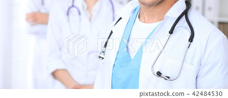 Groupe of unknown doctors standing straight in hospital office. Close Up of stethoscope at Groupe of unknown doctors standing straight in hospital office. Close Up of stethoscope at 42484530