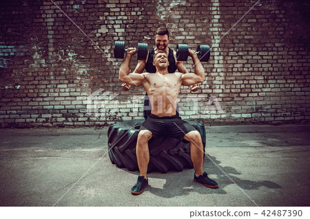 Two muscular athletes training 42487390