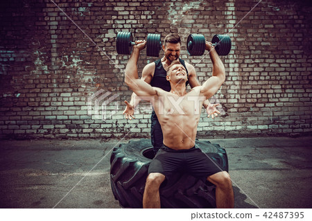 Two muscular athletes training 42487395