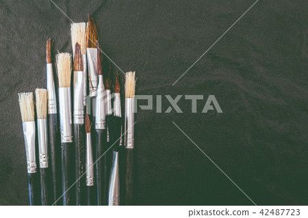 Paint brushes on black background Paint brushes on black background 42487723