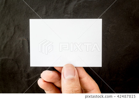 Hands holding blank business card on black 42487815