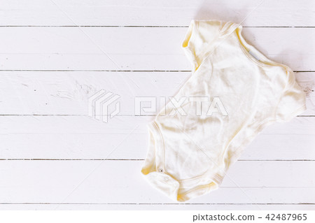 Clothes for baby on wooden background 42487965