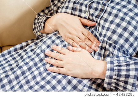 Woman lying on sofa with stomachache 42488293