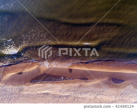 Narrow beach line, waves and ocean. Aerial view. Narrow beach line, waves and ocean. Aerial view. 42489124
