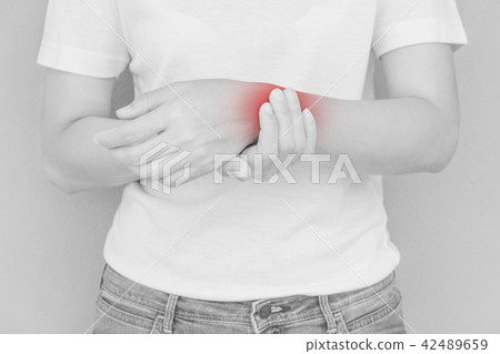 Woman scratching her elbow. 42489659