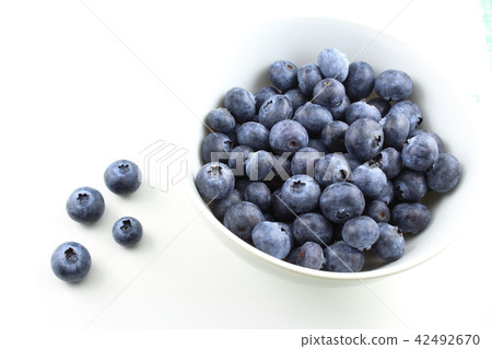 fresh blueberry fruits in a small white bowl fresh blueberry fruits in a small white bowl 42492670