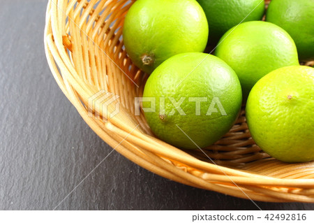 fresh lime fruits in a basket fresh lime fruits in a basket 42492816