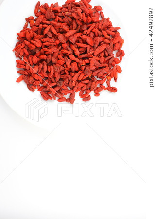 dried goji berries on a white plate dried goji berries on a white plate 42492892