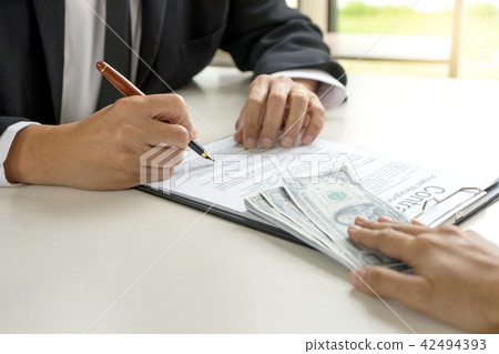 Business man give bribe to the officer Business man give bribe to the officer 42494393