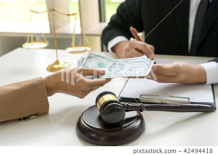 Judge lawyer gavel with bribe money in law firm 42494418