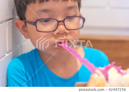 boy biting butter bread with long cheese. boy biting butter bread with long cheese. 42497256