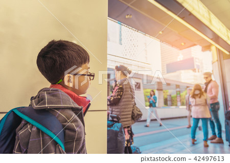 asian boy waiting in public park . asian boy waiting in public park . 42497613