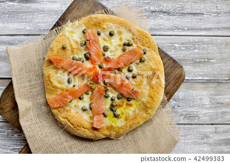 Pizza with salmon and basil and capers. Traditional Italian pastries. Copy space 42499383