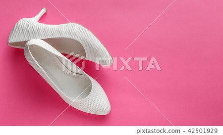 White wedding shoes on pink background White wedding shoes on pink background 42501929