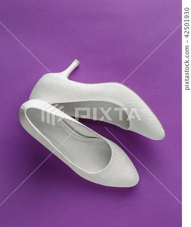 White wedding shoes on purple background White wedding shoes on purple background 42501930