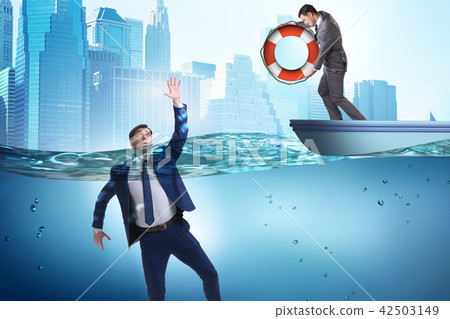 Businessman being saved from drowning Businessman being saved from drowning 42503149