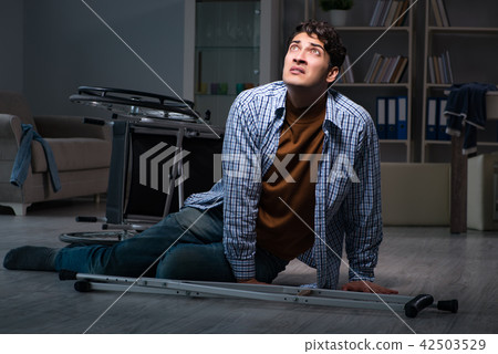 Man fell off wheelchair sitting on the floor Man fell off wheelchair sitting on the floor 42503529