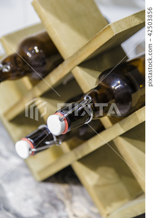 Wooden stand for bottles on the table in the Wooden stand for bottles on the table in the 42503856