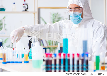 Young chemist student working in lab on chemicals 42503857