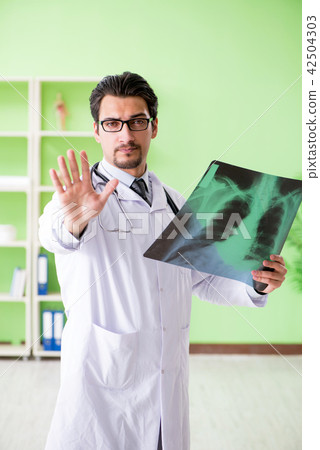 Doctor radiologist looking at x-ray scan in hospital 42504303
