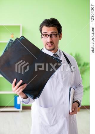 Doctor radiologist looking at x-ray scan in hospital 42504307